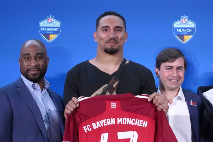 NFL International chief operating officer Damani Leech (left), New England Patriots fullback Jakob Johnson (center) and NFL executive vice president vice president of club business and league events Peter O'Reily pose during NFL International press conference at the Los Angeles Convention Center.